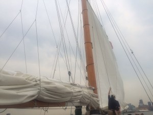 Members of the staff lifting the sails