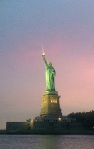 The Statue of Liberty shining with New York's sunset